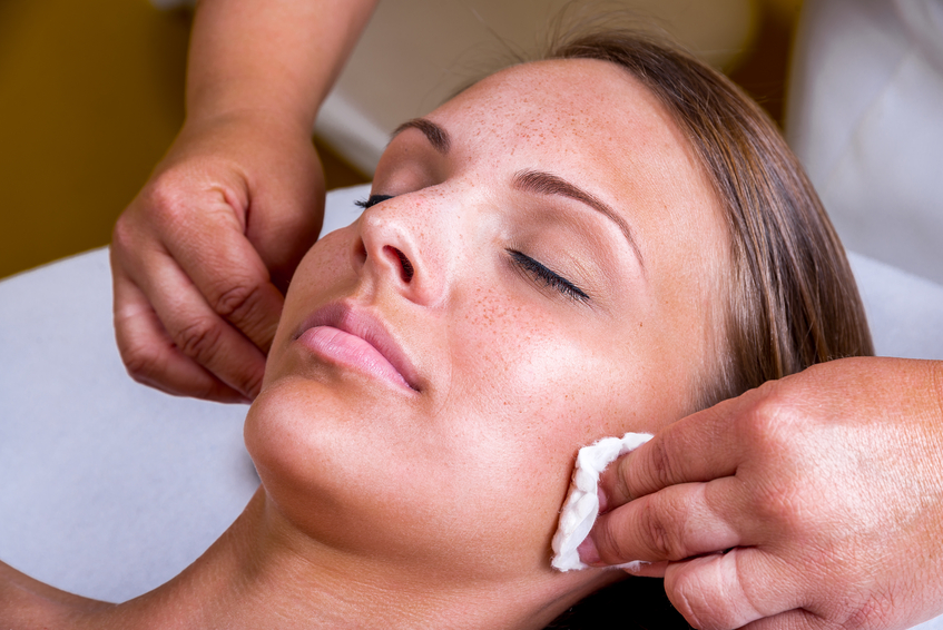 Freckles woman having a cosmetic treatment at the beauty salon.